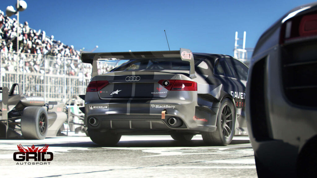 Exciting GRID Autosport Audi Racecar in Motion on Racetrack Wallpaper