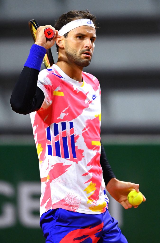 Grigor Dimitrov tennis action wallpaper vibrant white shirt neon patterns holding racket ball