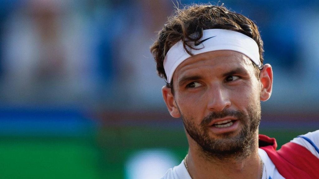 Close-up portrait of tennis star Grigor Dimitrov wearing white headband on outdoor court background Wallpaper