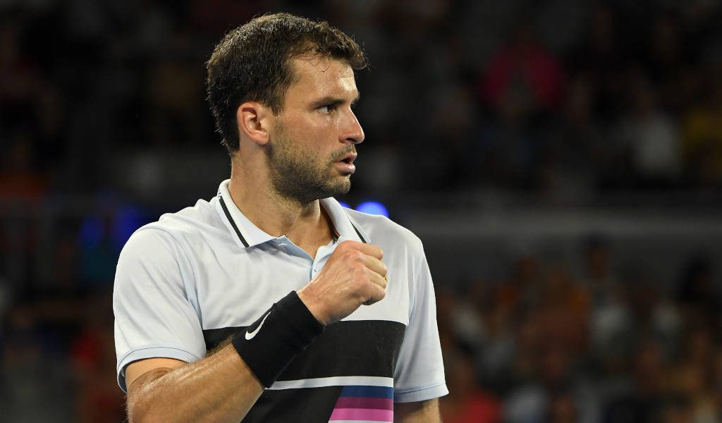 Grigor Dimitrov focused tennis star clenched fist sportswear stadium background wallpaper