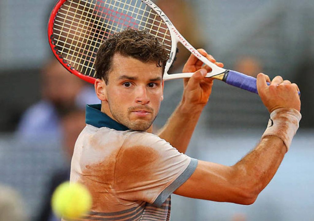 Grigor Dimitrov in focused tennis action on clay court with Wilson Pro Staff racket wallpaper