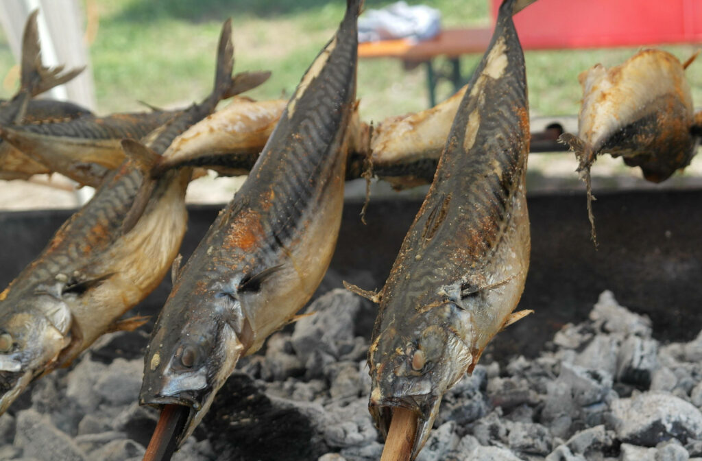 Grilled Mackerel Wallpaper: Smoky Charred Outdoor Cooking Scene