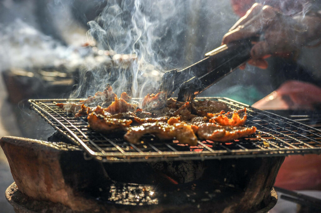 Grilling Meat on Parrilla: Rustic Wallpaper Background with Smoky Ambiance