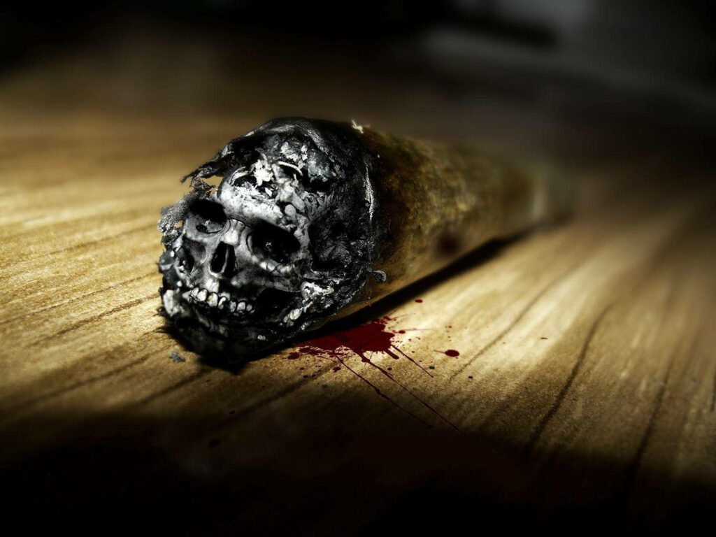 Gritty Aesthetics: HD Skull Cigarette Embraced by Blood Splatter Wallpaper
