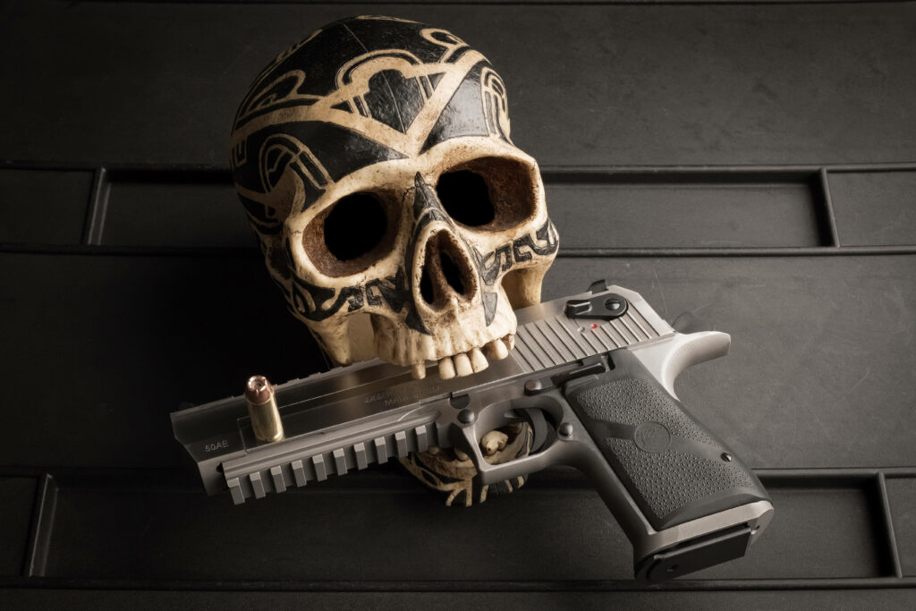 Gun-toting Inked Gangster Skull Spitting Metal Wallpaper