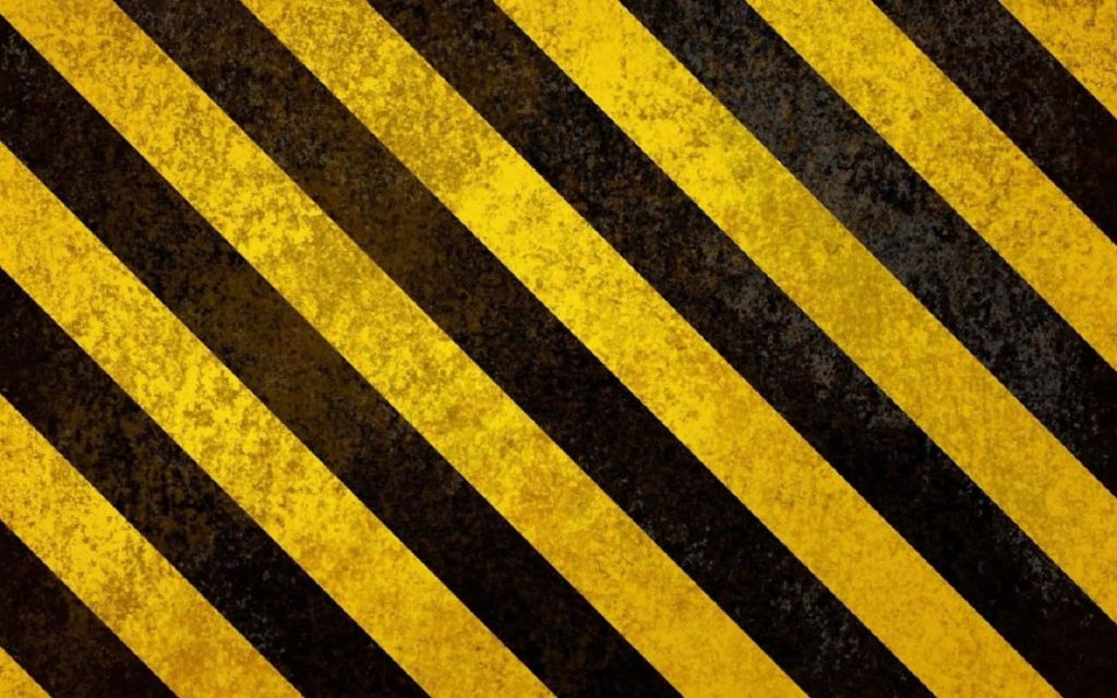 Weathered yellow and black caution pattern construction wallpaper for industrial and safety design