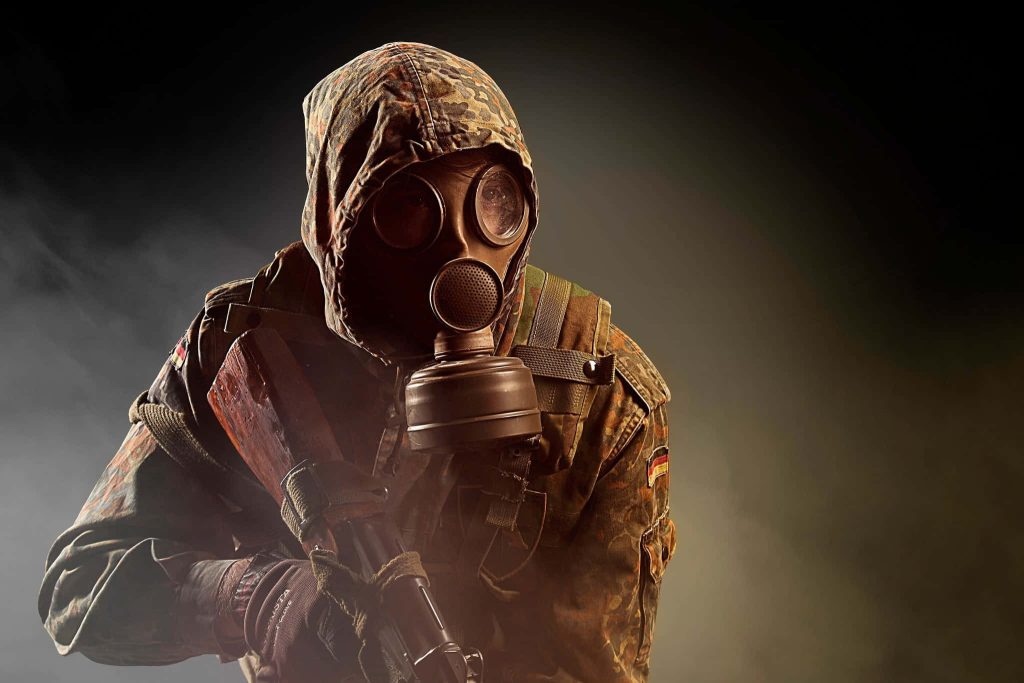 Soldier in gas mask Flecktarn camo rifle German flag patch smoky military tactical wallpaper