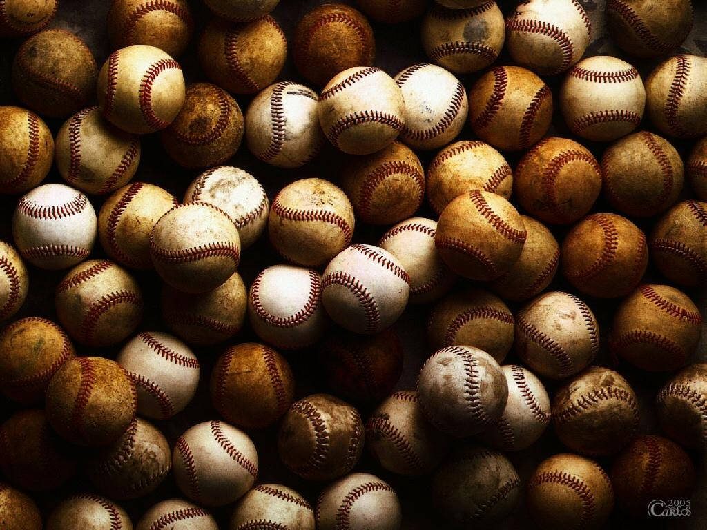 Realistic used baseballs with red stitching and scuffed leather texture sports wallpaper background