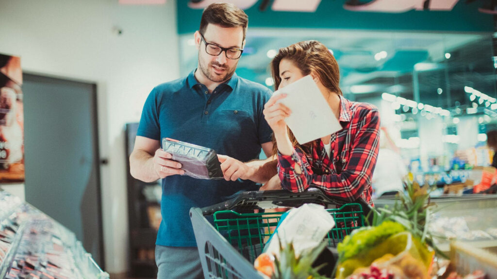 Couple Shopping in Grocery Store with Fresh Produce Wallpaper