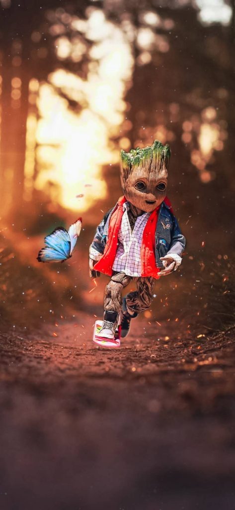 Groot skateboarding in denim jacket on sunny forest path with glowing blue butterfly wallpaper