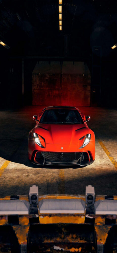 Ferrari Fever: Exploring Speed and Style in a Retro Warehouse Setting Wallpaper
