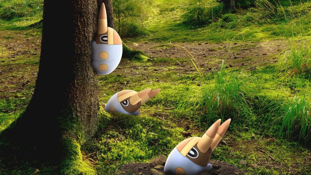 Three Grubbin Pokémon explore a vibrant mossy forest in detailed 3D digital art wallpaper