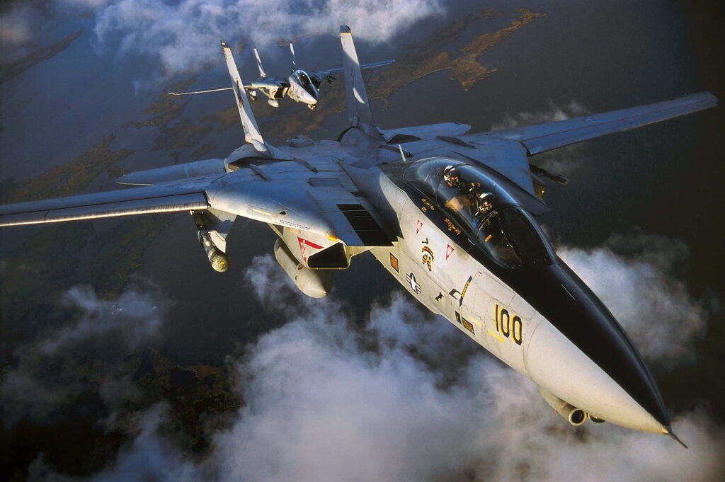 Two Grumman F-14 Tomcat jets in flight displaying variable-sweep wings and sleek design Wallpaper
