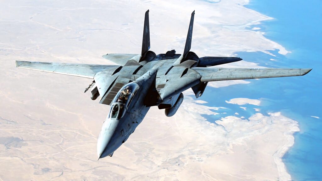 Grumman F-14 Tomcat jet flying over desert under clear blue sky military aircraft wallpaper
