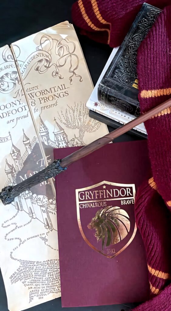 Gryffindor wizard accessories wand Marauders Map maroon scarf Harry Potter fan collection wallpaper