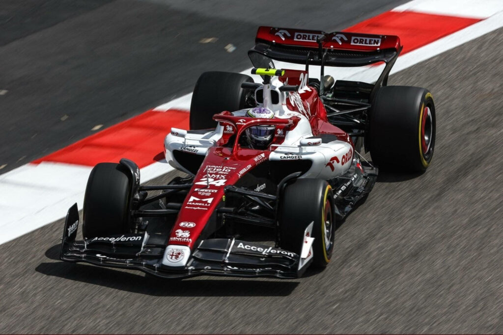 Guanyu Zhou F1 car front view sleek red and white livery racing on track wallpaper background