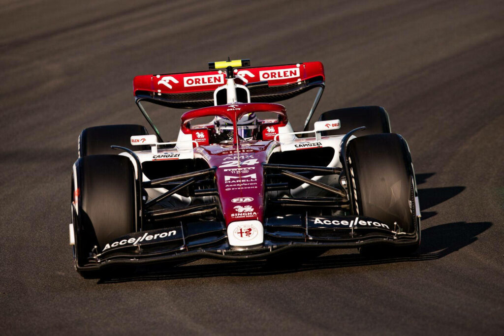 Guanyu Zhou racing red white Formula 1 car high speed dynamic professional motorsport wallpaper