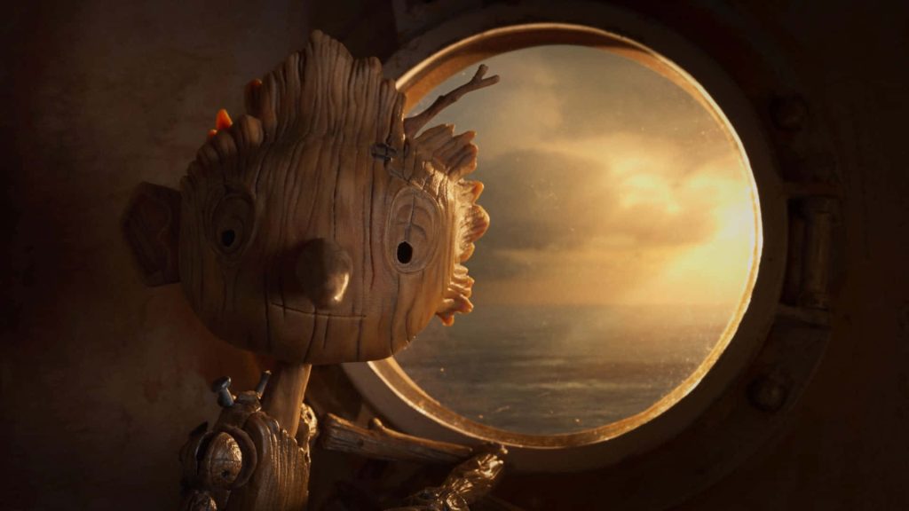Pinocchio in warm golden light gazing through ship porthole stop motion wallpaper background