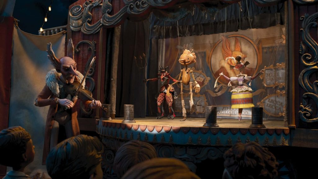Count Volpe playing violin for Pinocchio and Spazzatura on a dark moody puppet stage Wallpaper