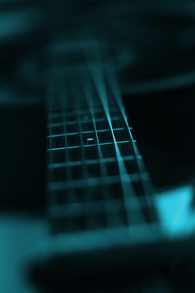 Intricate Guitar Fingerboard Close-Up: Artistic Wallpaper Background
