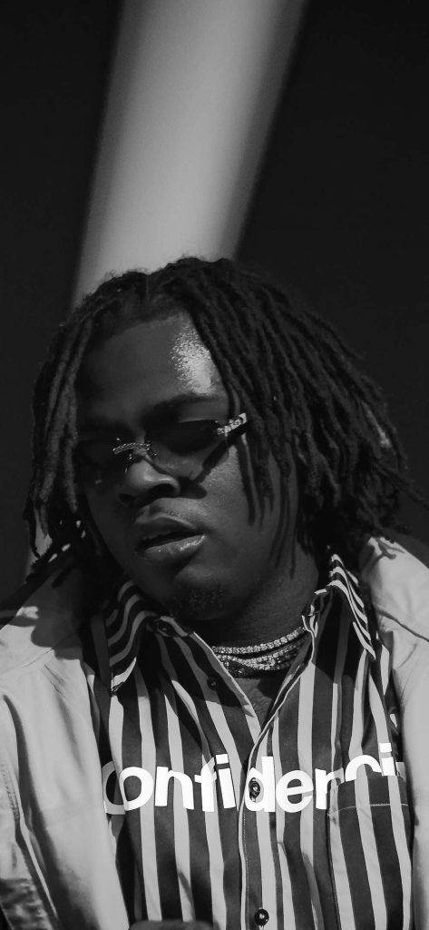 Grayscale portrait of rapper Gunna in sunglasses iced chains striped confidence shirt wallpaper