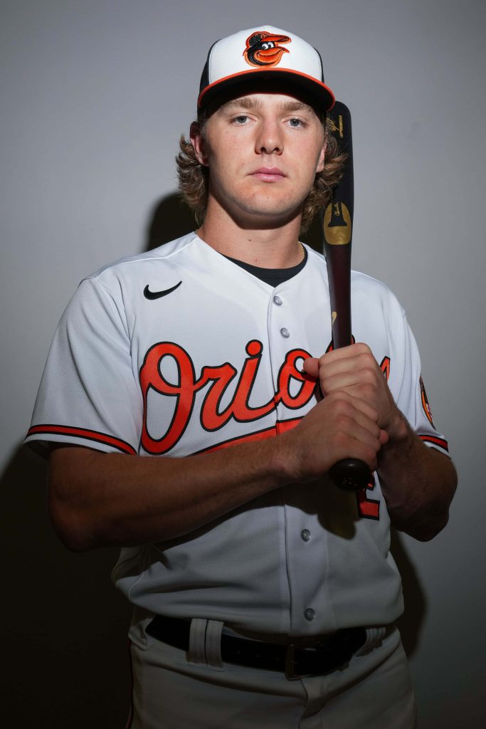Baltimore Orioles Gunnar Henderson in white jersey holding bat studio portrait MLB wallpaper