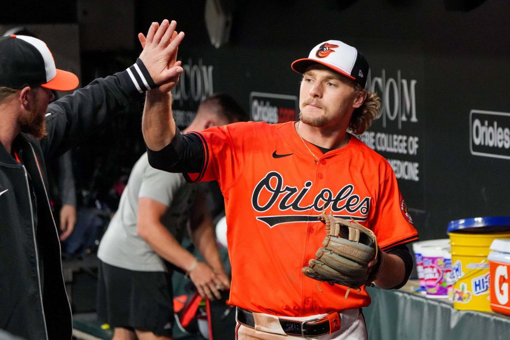 Baltimore Orioles Gunnar Henderson giving celebratory high-five in orange jersey baseball wallpaper