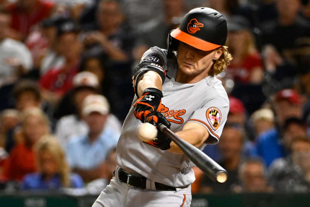 Baltimore Orioles Gunnar Henderson mid-swing in gray uniform dynamic MLB stadium wallpaper