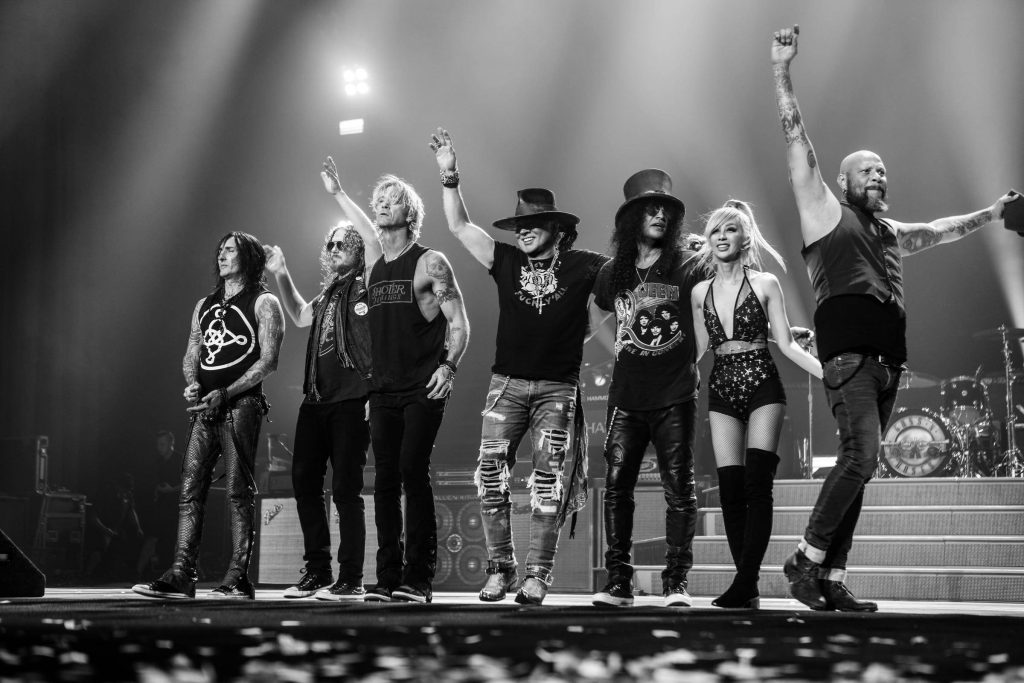 Black and white Guns N Roses concert wallpaper with Axl Rose Slash Duff McKagan on stage