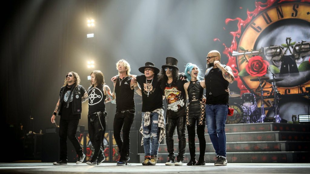 Guns N Roses live concert with Axl Rose and Slash on stage vibrant lighting rock wallpaper