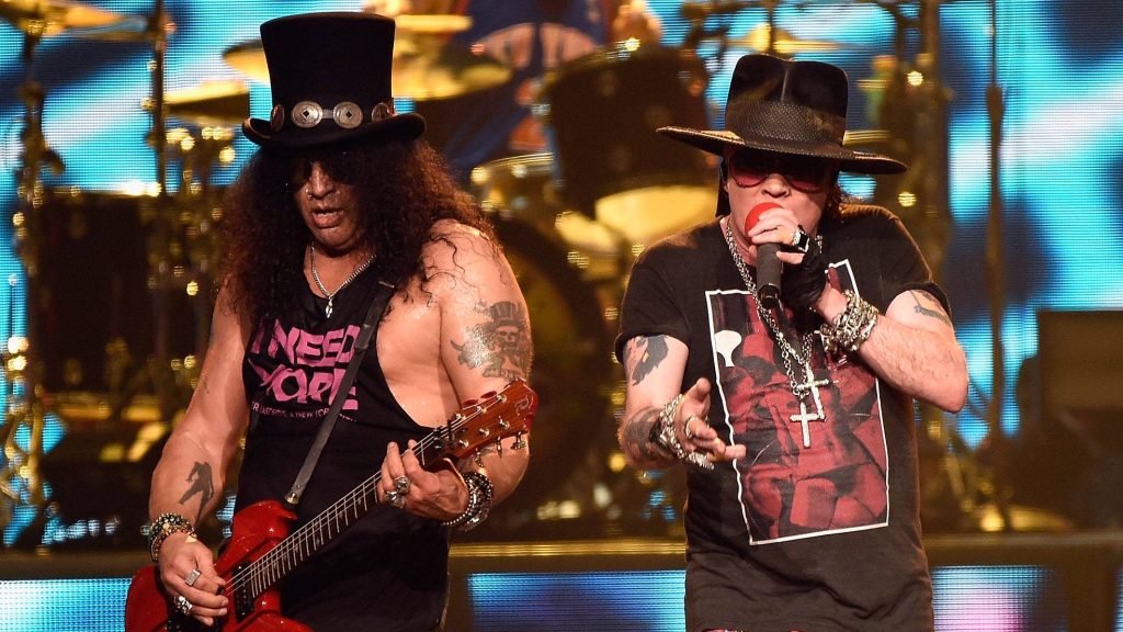 Guns N Roses live concert wallpaper Slash with top hat and Axl Rose on blue lit stage