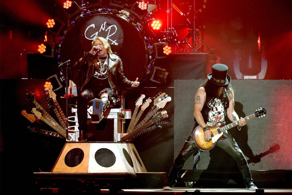 Guns N Roses live stage Axl Rose on throne Slash top hat classic GNR logo concert wallpaper