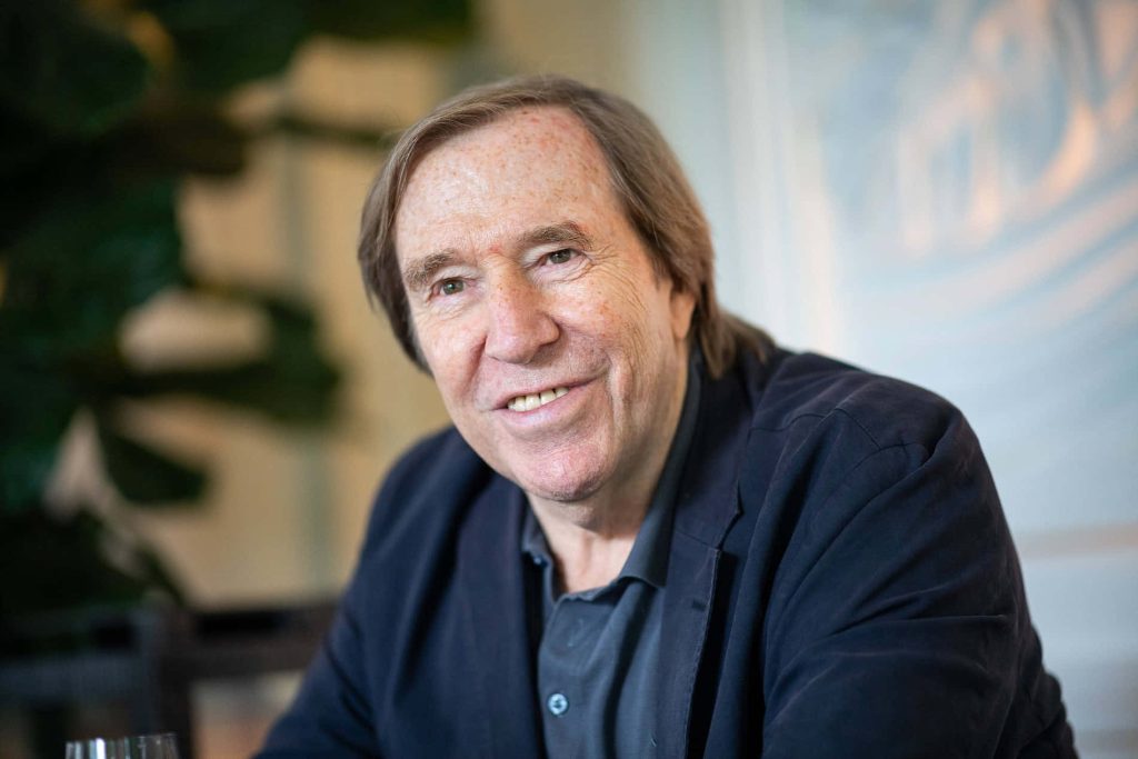 Portrait of German football legend Günter Netzer in navy blazer with warm friendly smile Wallpaper