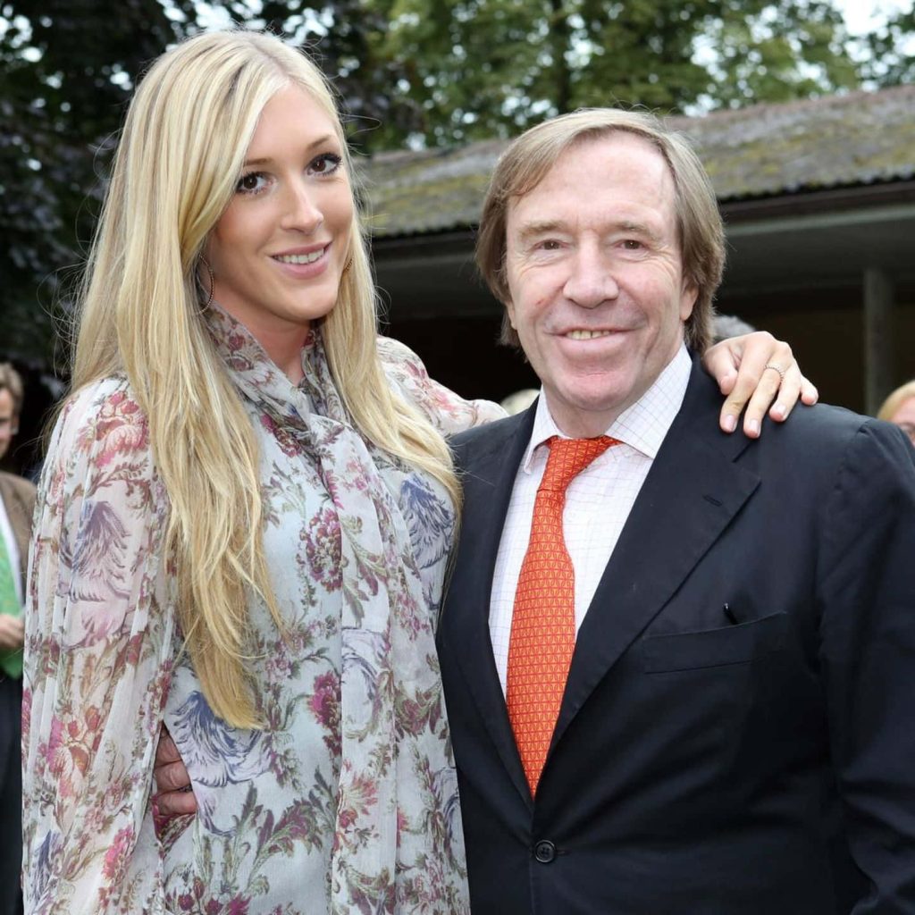 Günter Netzer with daughter Alena in stylish portrait wearing suit and floral dress wallpaper background