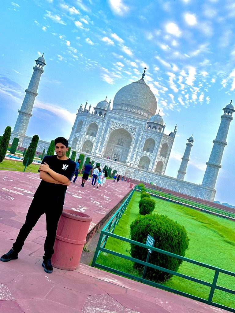 Guru Randhawa in black outfit posing at Taj Mahal Agra bright daylight vibrant wallpaper background