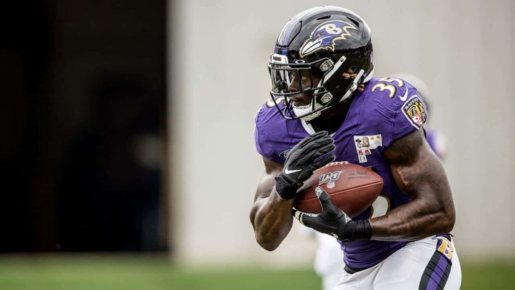Baltimore Ravens running back Gus Edwards in action sharp sports photography wallpaper background