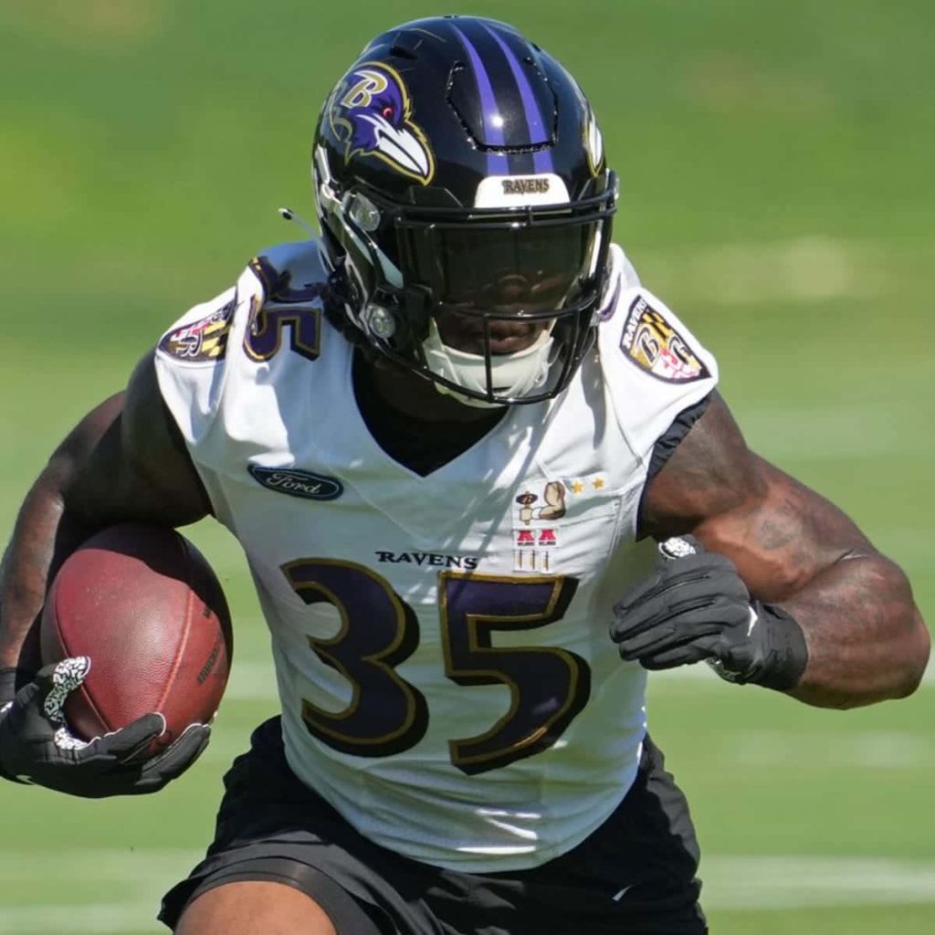 Baltimore Ravens Gus Edwards sprinting in white jersey 35 NFL action high-quality wallpaper