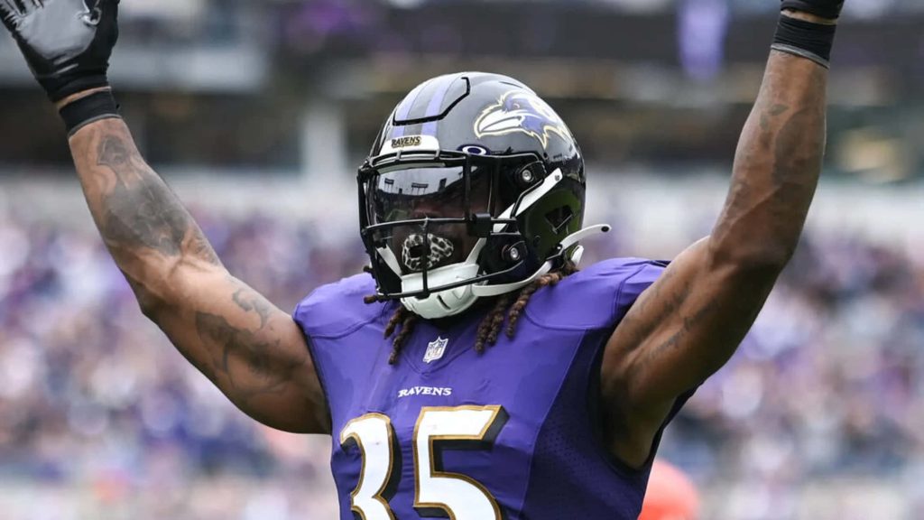 Baltimore Ravens Gus Edwards #35 celebrating victory on field vibrant NFL football wallpaper background