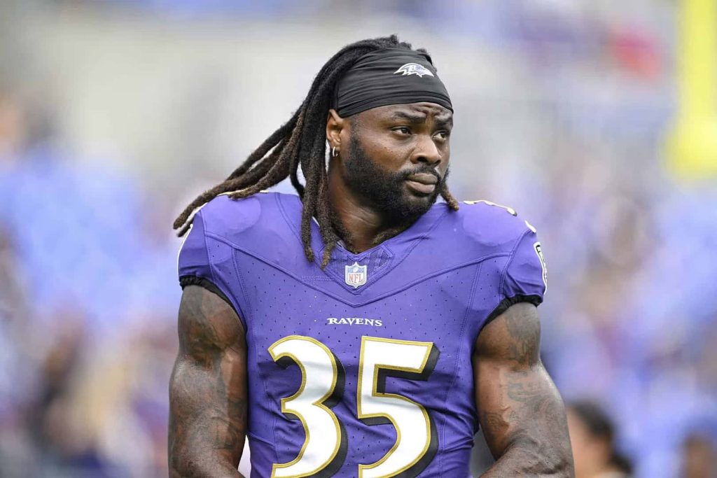 Gus Edwards Baltimore Ravens #35 intense focused game action vibrant stadium wallpaper