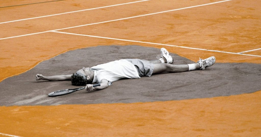 Gustavo Kuerten heart pose on Roland Garros red clay celebrating French Open tennis victory wallpaper