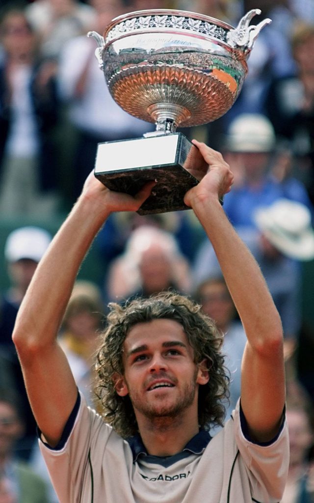 Gustavo Kuerten lifting Coupe des Mousquetaires trophy celebrating French Open win at Roland Garros Wallpaper
