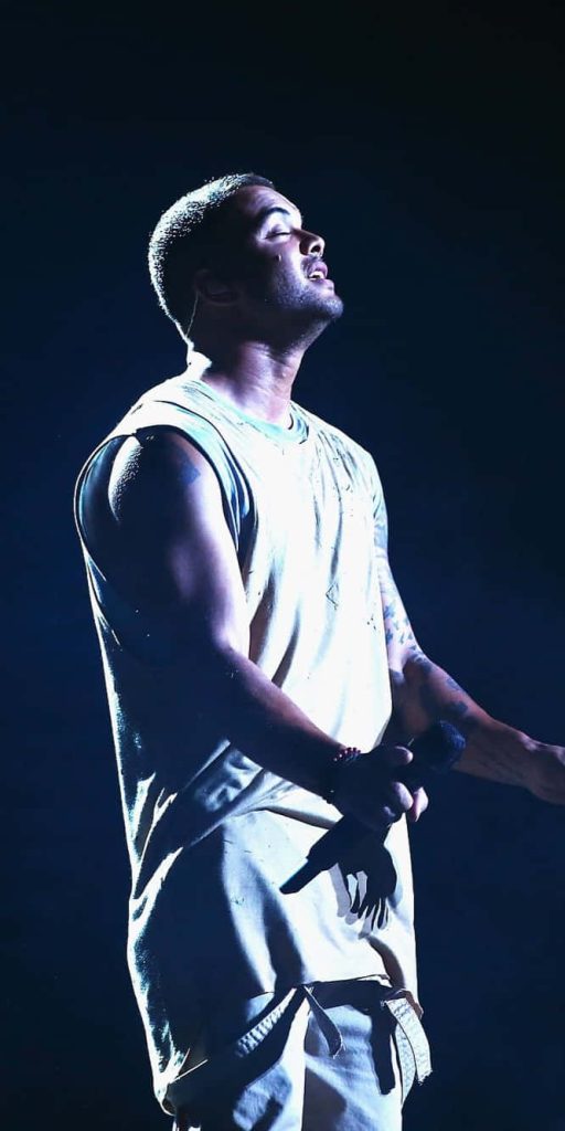 Guy Sebastian live concert wallpaper dramatic side profile sharp stage lighting moody background