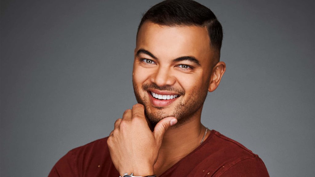 Guy Sebastian vibrant portrait in rust shirt studio lighting grey background high resolution close-up Wallpaper