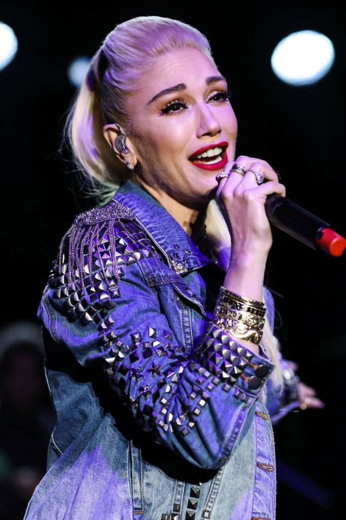 Gwen Stefani live concert singing in studded denim jacket with platinum hair and red lips Wallpaper