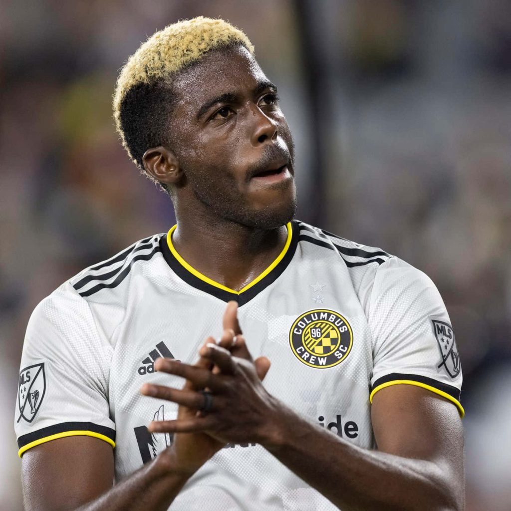Columbus Crew forward Gyasi Zardes clapping in white kit with blonde buzz cut during match Wallpaper