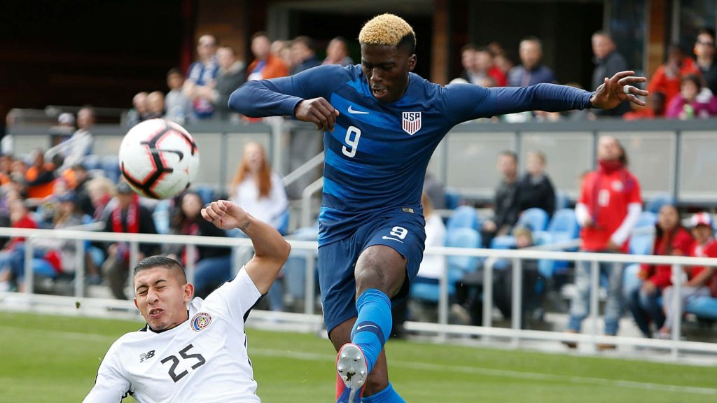 US soccer forward Gyasi Zardes battles Costa Rica defender Marvin Loria in intense match action Wallpaper