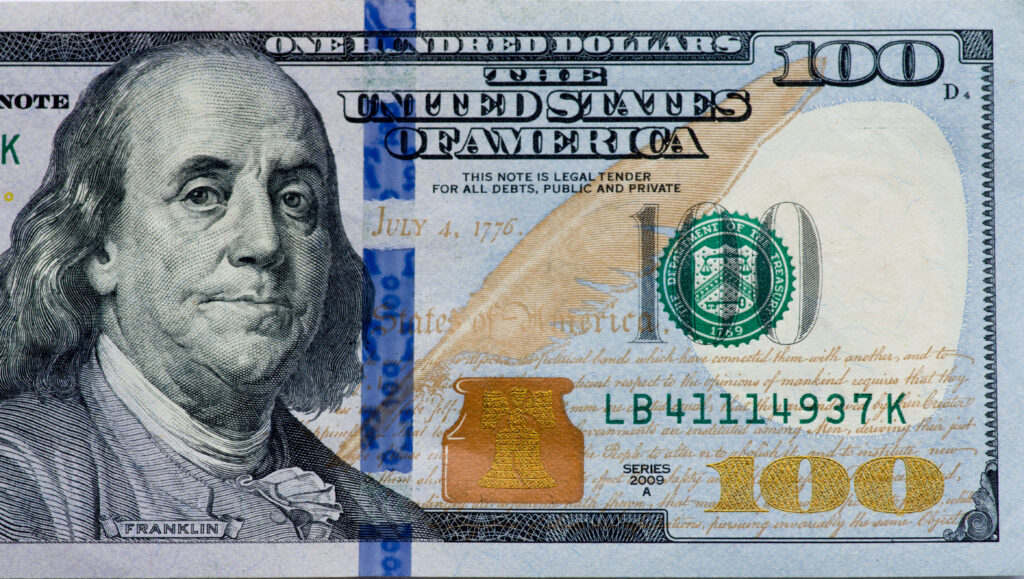 Frozen Fortune: A Captivating Closeup of a 100-Dollar Bill, Ideal Wallpaper for Your Desktop