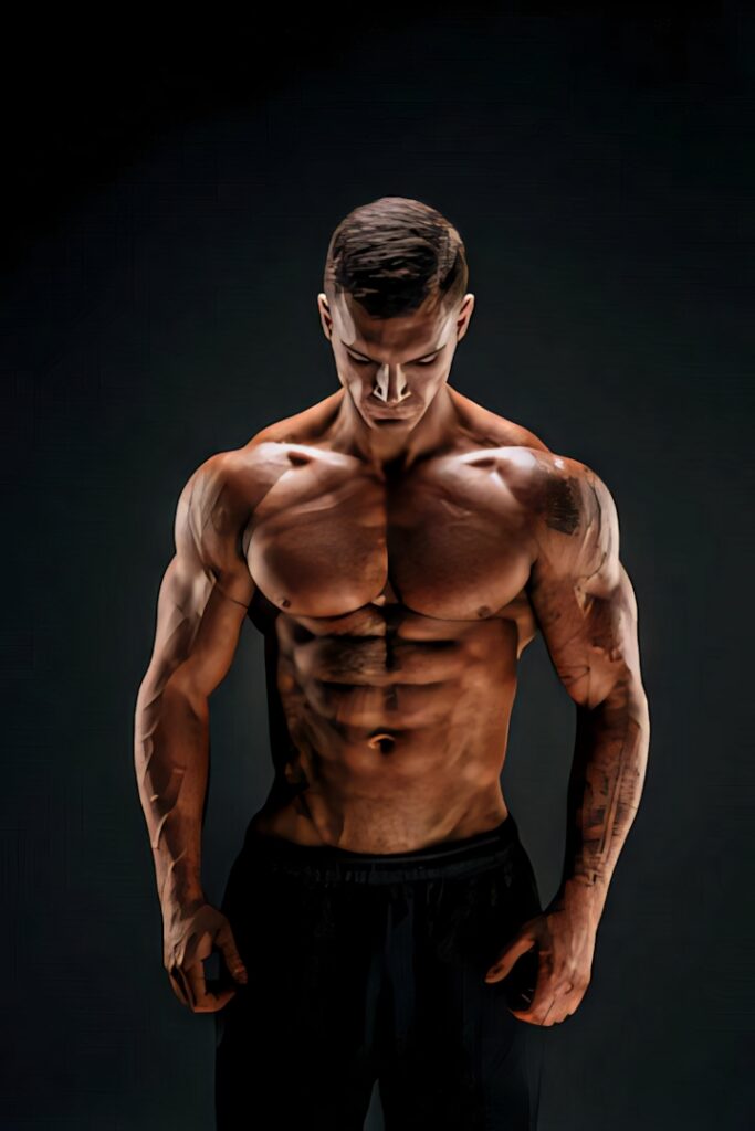 HD portrait of muscular bodybuilder with defined muscles and focused lighting on dark background Wallpaper