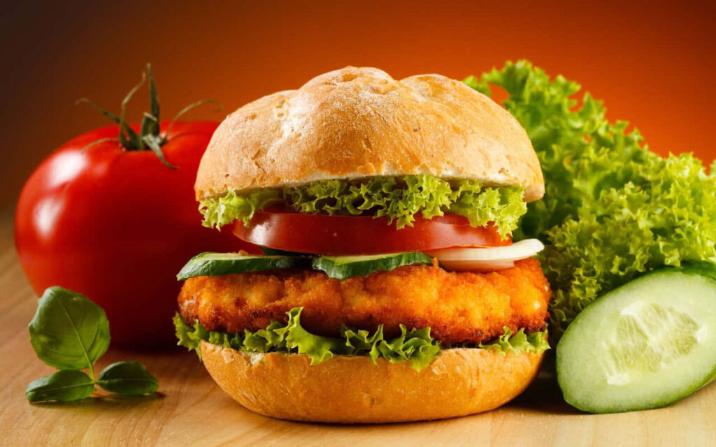Vibrant HD Burger Wallpaper: Tasty Lettuce, Tomatoes & Golden Patty