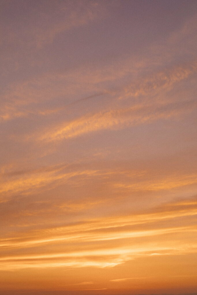 Serene HD Phone Wallpaper: Soft Clouds & Golden Sunset Background